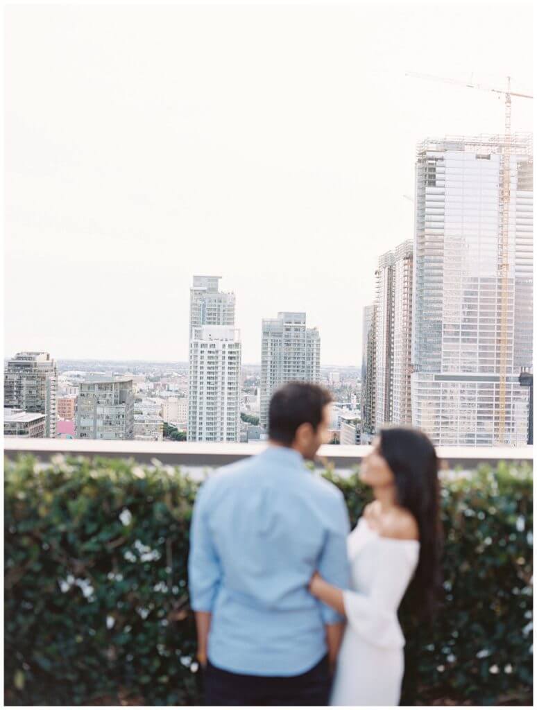 Downtown LA Engagement Session Photography with an urban vibe with lots of buildings and a helipad