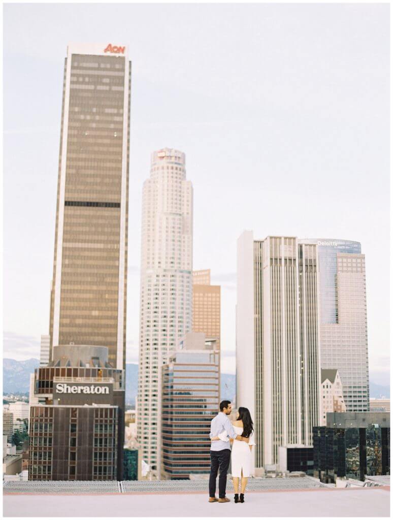 Downtown LA Engagement Session Photography with an urban vibe with lots of buildings and a helipad